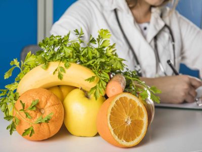 close-up-fresh-juicy-fruits-front-female-dietician